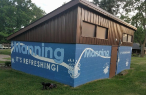 Manning, Iowa's logo and slogan in a park